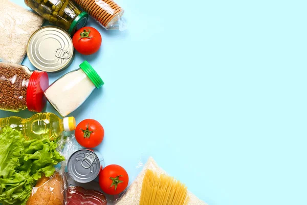 Food supplies for the period of quarantine on blue background. Set of grocery items from canned food, vegetables, pasta, cereal. Food delivery concept. Donation concept.