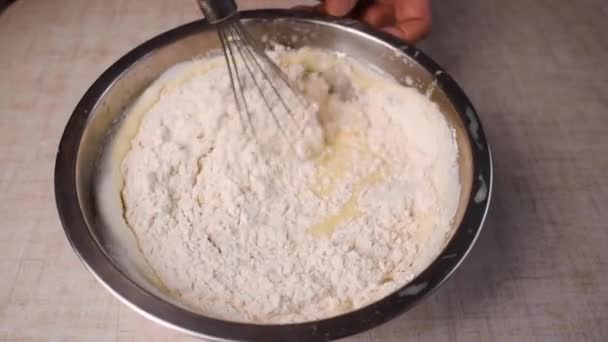 Process of making and whisking the dough, womans hand mixing liquid dough — Stock Video