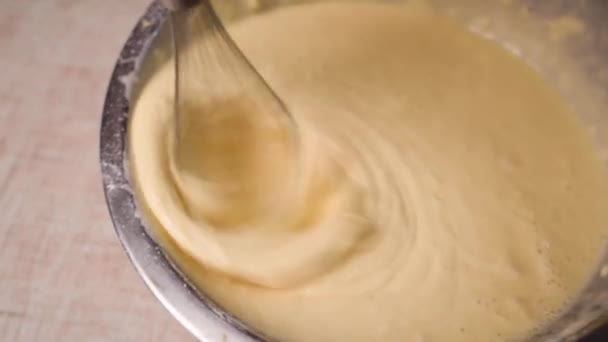 Proces výroby a šlehání těsta, ženy ruční míchání tekutého těsta s whisk v misce. — Stock video