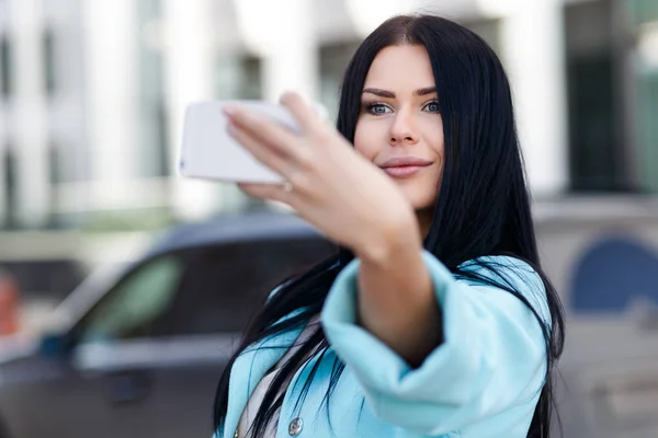 Женщина фотографирует себя по телефону — стоковое фото