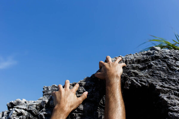 Man climbs on mountain slope