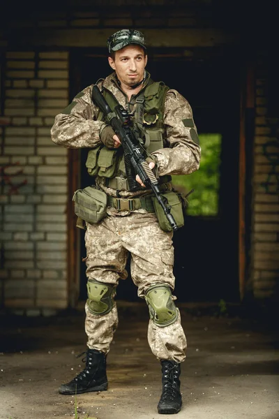 Soldier in camouflage with gun