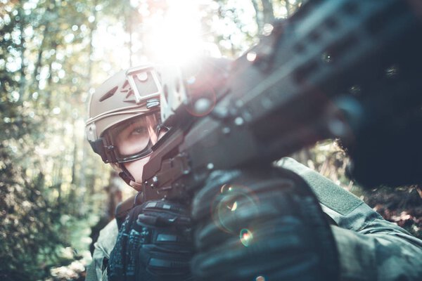 Image of military man in helmet and with submachine gun
