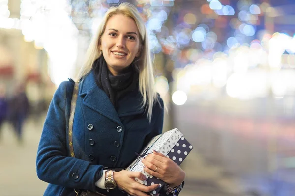 Image of woman in coat with gift in box — Stock Photo, Image