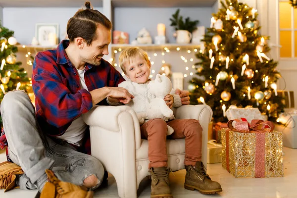 New Years photo of son and father in armchair