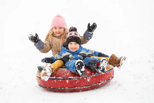 Photo of cheerful girl and boy riding tubing — Stock Photo, Image