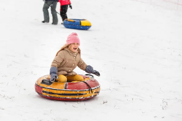 Image of happy girl riding tubing in winter park — Stock Photo, Image