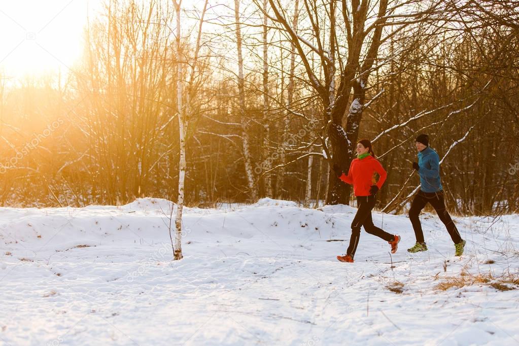 Photo of sports woman and man on morning run in winter