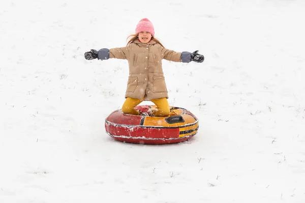 Picture of happy girl riding tubing in winter park — Stock Photo, Image