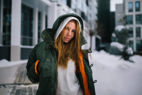 Imagem de menina loira no capuz e na jaqueta contra o dia de inverno — Fotografia de Stock