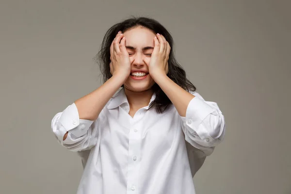 Hermosa chica en una camisa blanca muestra emociones - sonrisa, diversión . — Foto de Stock