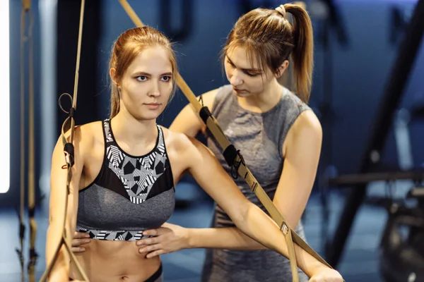 Woman with trainer on arm muscle training — Stock Photo, Image