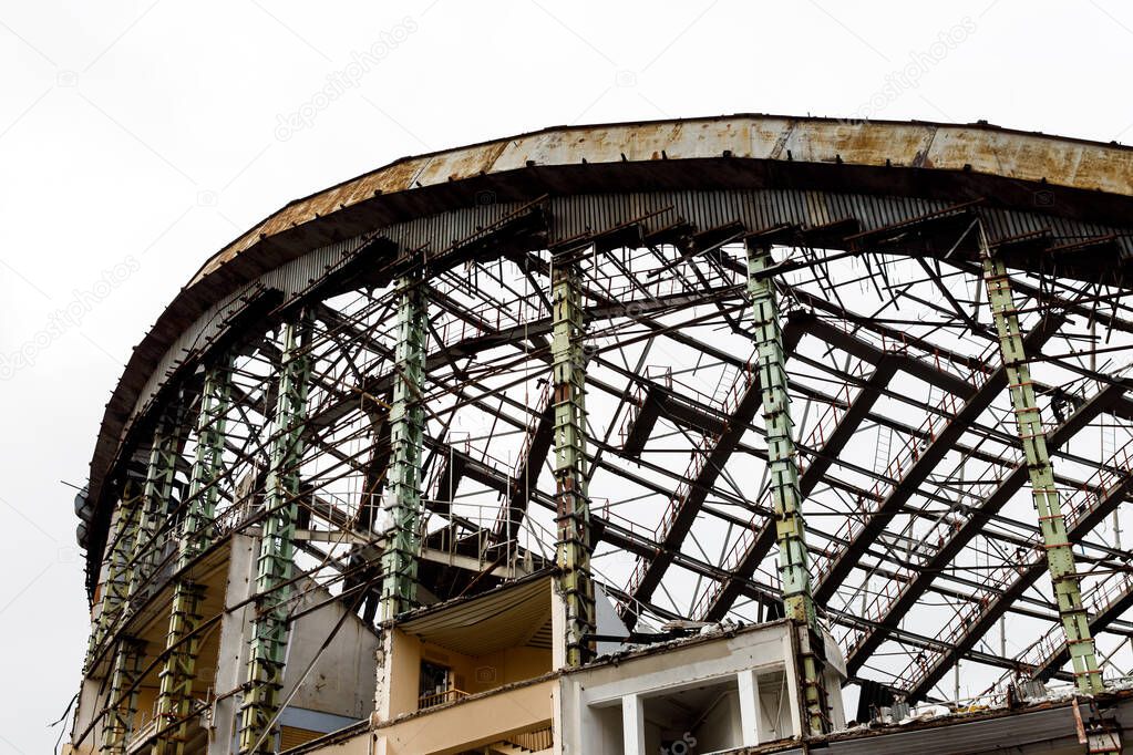 Tall dilapidated building with iron ceilings against clear sky