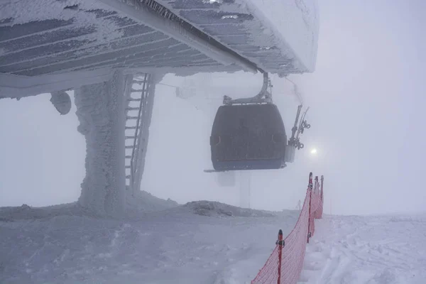 Ski lift in heavy snow. Heavy fog. Bad visibility