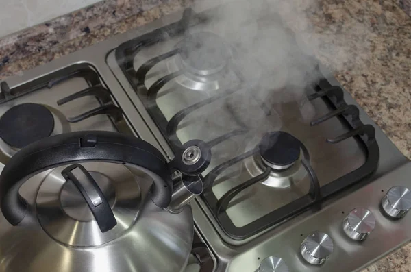 Chaleira de aço em um fogão a gás, cozinha caseira, ferver água para o chá. Vista superior — Fotografia de Stock