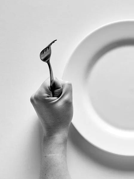 Fork and knife in hands black and white — Stockfoto