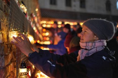15-10-2019 Riga, Letonya. Duvarda mum yakan bir kadın