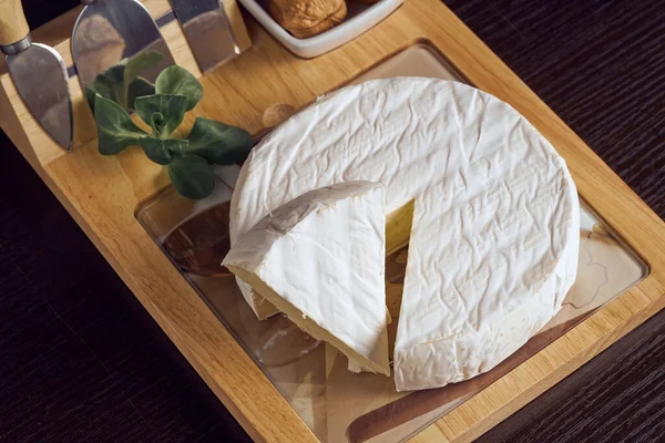 Round soft cheese, with a section cut. — 스톡 사진