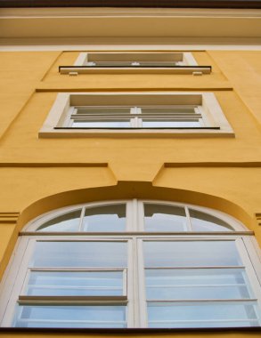 white plastic window on the yellow facade