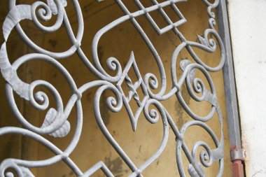 Wrought iron railing. Shapes of leaf and elegant curves. Toned image.