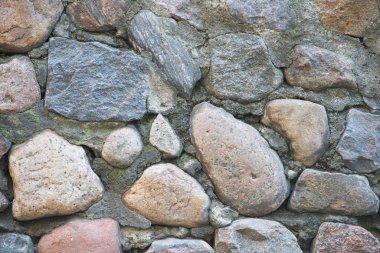 Taş bir duvarın dokusu. Eski kale taşından duvar dokusu. Arka plan ya da doku olarak taş duvar. Bir taş duvarın parçası, arkaplan veya doku için