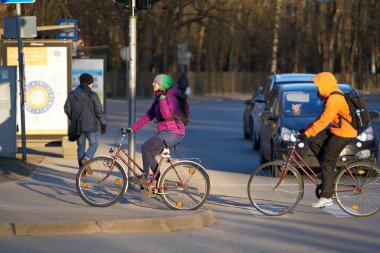 23-03-2020 Riga, Latvia. Cyclists cross the road in front of cars.