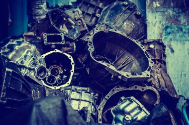 Old Machine parts in warehouses. Car parts in old warehouses. Used vehicle part for recycling in the scrap yard garage. Recycle goods/meta.