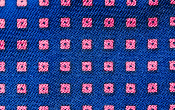 Solid background of blue fabric with a texture pattern. Close-up