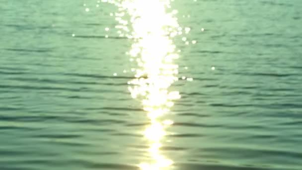 Blurred reflected in the sea sun ray and sunrise over the calm sea. the sun rises center above the sea and a big beautiful ray is reflected on the surface of the water — Stock Video