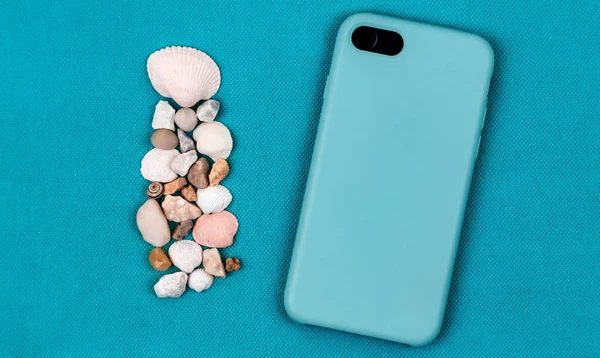 Черный мобильный телефон или смартфон в голубом футляре — стоковое фото