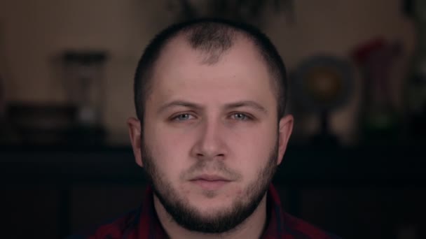 A young guy of European appearance in a plaid shirt closeup looks in surprise. Emotion concept — 비디오