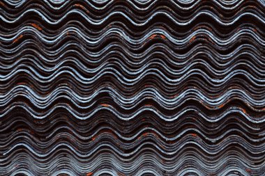 A stack of leaves of wave slate. Side view of a large number of 