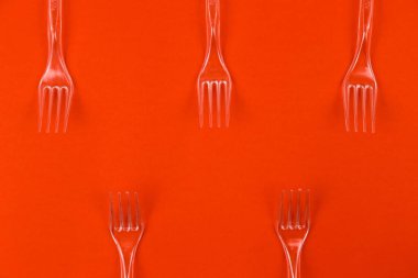 Turuncu arka planda temiz plastik çatal yakın plan. Tek kullanımlık tablo kalıbı