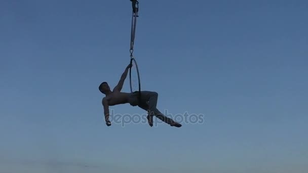 Atleet acrobat in de hemel toont cijfers. — Stockvideo