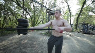 Man is exercising stretching a rubber band.