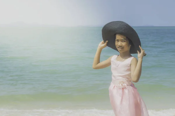 Glückliches kleines Mädchen spielt am Strand. — Stockfoto