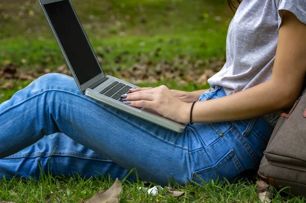 Hermosa mujer de un estudiante sentado con el ordenador portátil y relajarse en — Foto de Stock