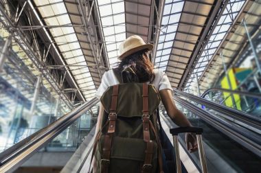 Sırt çantası travelator Uluslararası Havaalanı üzerinde olan kadın