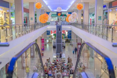 large beautiful multi-level shopping center for trade and business and selling things with an escalator and people