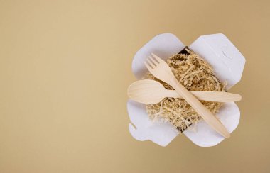 Çevresel sofra takımı ve ekolojik yiyecek kapları, tahta kaşıklar ve çatallarla arka planda hafif bir arkaplan ve metin için boşluk. Doğayla ilgilenmek, gezegenin saflığını korumak.