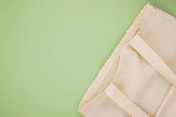 linen eco bag on a pastel green background, top view. the concept of not using plastic. nature protection