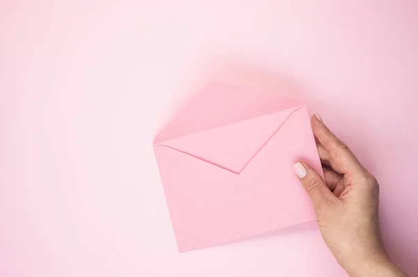 Mano Una Mujer Sostiene Sobre Rosado Abierto Sobre Fondo Rosado — Foto de Stock