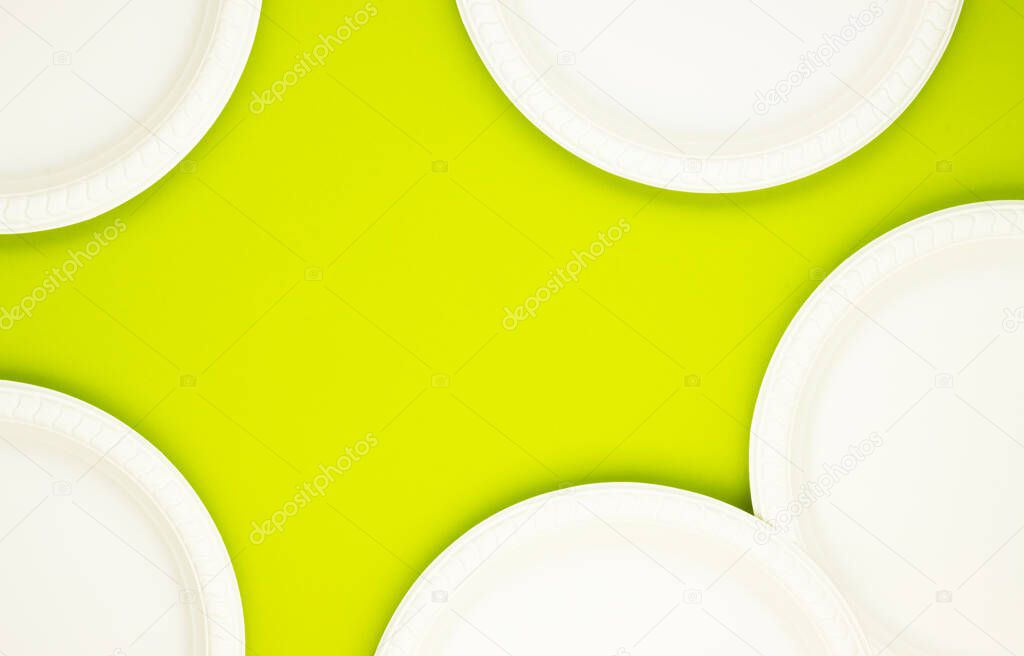 Eco-friendly biodegradable paper plates on a green background. preserving the purity of nature. the rejection of the plastic