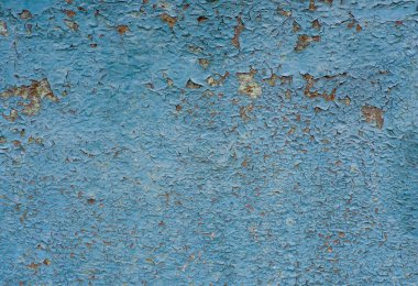 Arka plan olarak bir zamanlar boyalı metal olan kapının paslı yüzeyi..