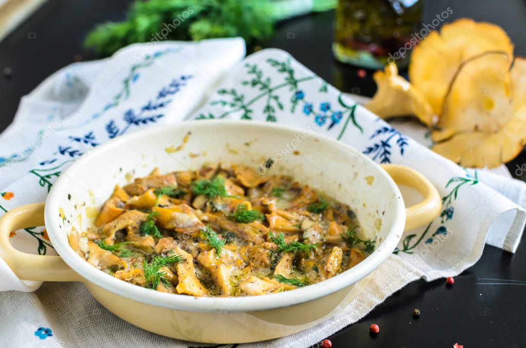 Homemade baked chanterelle mushrooms in frying pan isolated