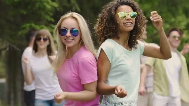 Jóvenes mujeres positivas bailando con amigos al aire libre, celebración de la vida, diversión — Vídeo de stock