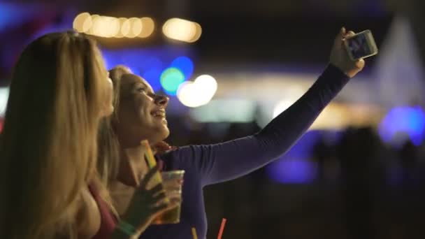 Pretty female friends posing for selfie with cocktails, admiring self-portraits — Stock Video