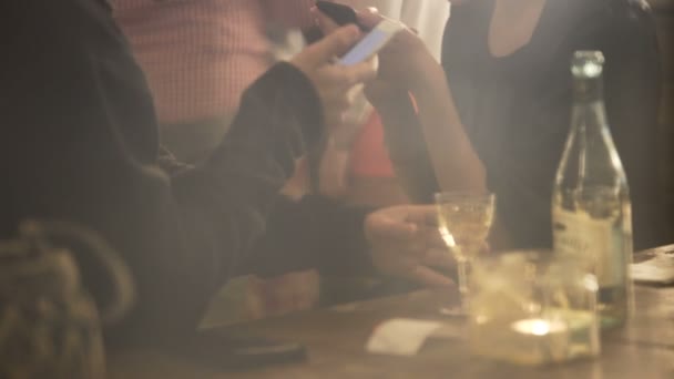 Занятые люди используют смартфоны на вечеринке, заменяя общение гаджетами — стоковое видео