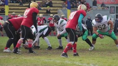 Kiev, Ukrayna - Yaklaşık Ekim 2015: Amerikan futbolu oynayan takımlar. Scrimmage hattına gergin saldırı, başarıyı kutlayan kazananlar, gridiron maçı