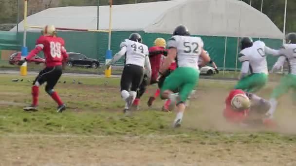 Opposing team tackles player with ball, annoyed footballer pushing rival athlete — Stock Video